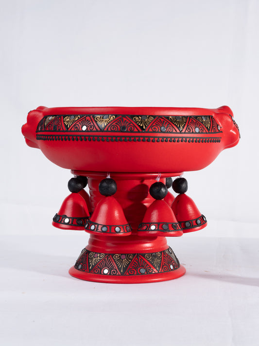 Top view of a colorful handpainted terracotta urli with floral art, placed on a white background, ideal for festive decor or pooja setups.